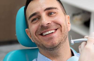 Happy patient's smile after treatment at Smile Dental Care